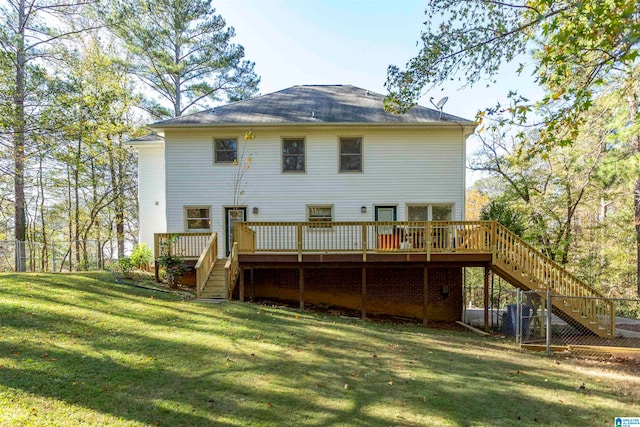 rear view of property featuring a deck and a lawn