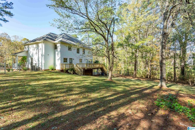 view of yard with a wooden deck and central AC