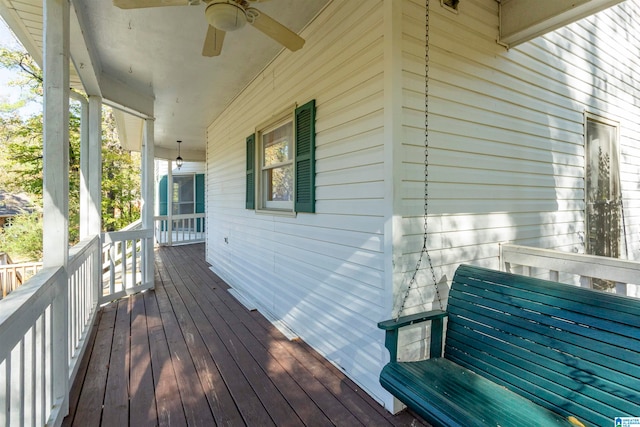 wooden deck with a porch and ceiling fan