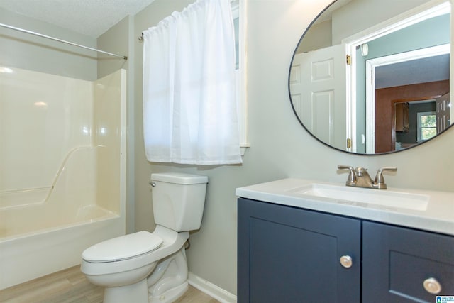 full bathroom with a textured ceiling, toilet, shower / tub combo with curtain, vanity, and hardwood / wood-style flooring