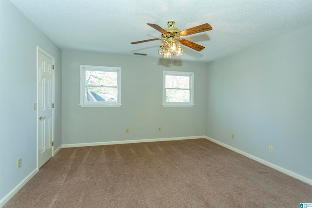 empty room featuring plenty of natural light, ceiling fan, and light carpet