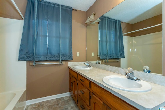 bathroom with vanity and a textured ceiling