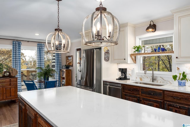 kitchen with sink, stainless steel appliances, tasteful backsplash, dark hardwood / wood-style flooring, and a chandelier