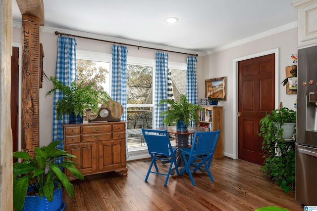 dining room with crown molding and dark hardwood / wood-style floors