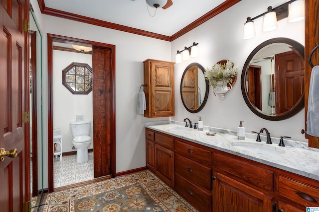 bathroom featuring crown molding, vanity, and toilet