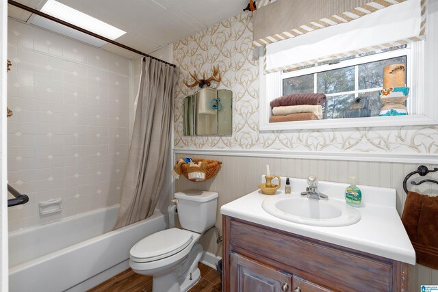 full bathroom with hardwood / wood-style floors, vanity, wood walls, toilet, and shower / tub combo with curtain