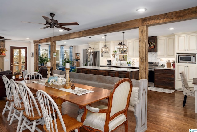 dining room featuring beam ceiling, dark hardwood / wood-style floors, ceiling fan, and crown molding