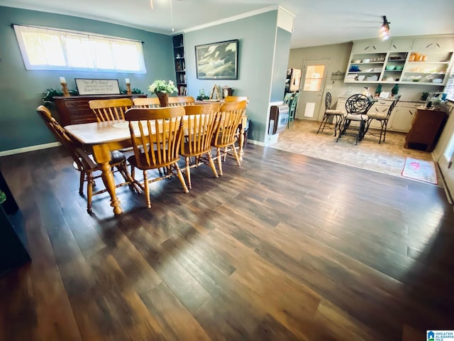 dining room with crown molding and dark wood-type flooring