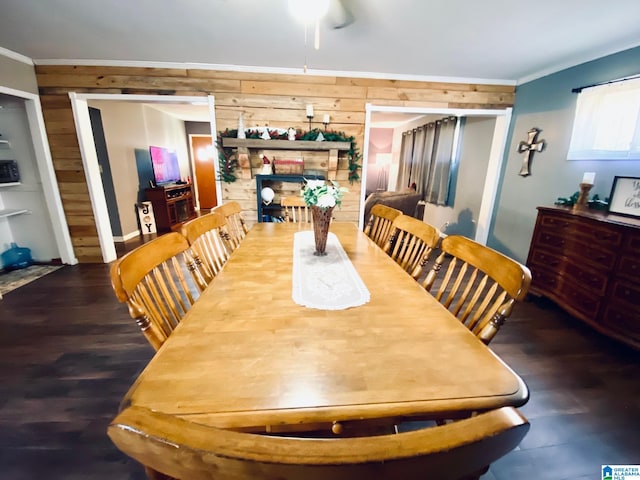 dining area with wooden walls, crown molding, and wood-type flooring