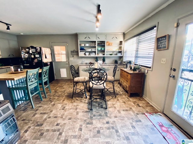 dining area featuring rail lighting and heating unit