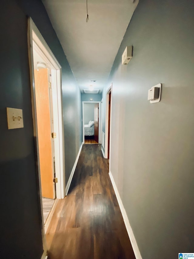 corridor with hardwood / wood-style floors