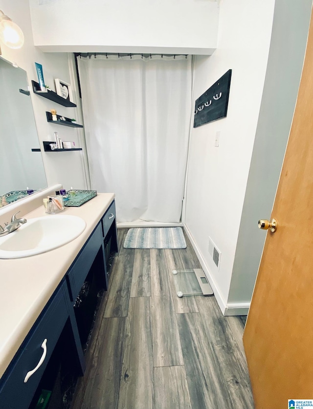 bathroom featuring vanity and wood-type flooring