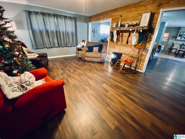 living room featuring hardwood / wood-style floors and wooden walls