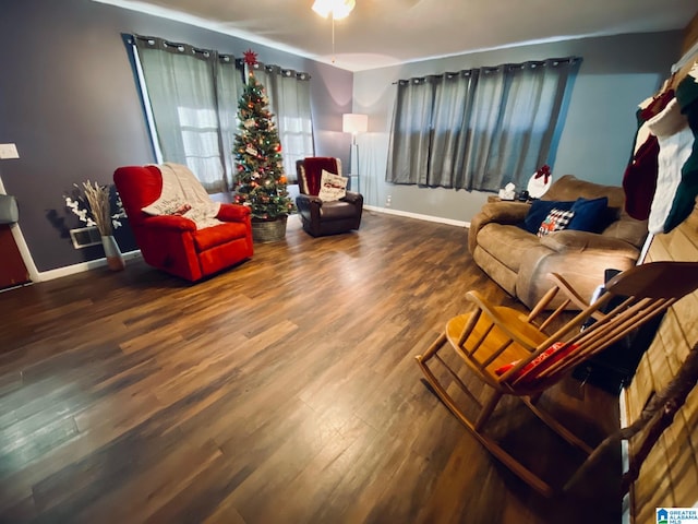 living room featuring hardwood / wood-style floors and ceiling fan