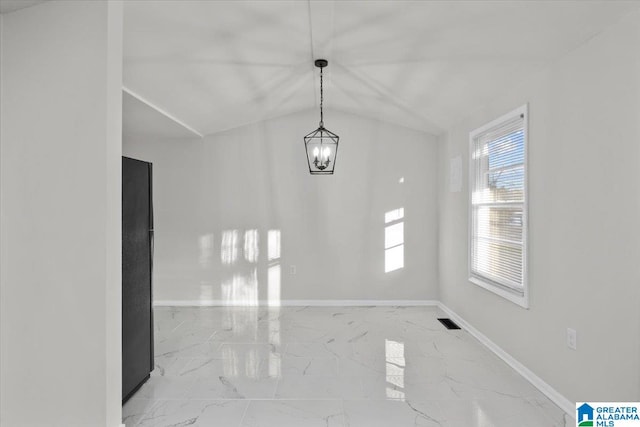 unfurnished dining area with a chandelier and vaulted ceiling