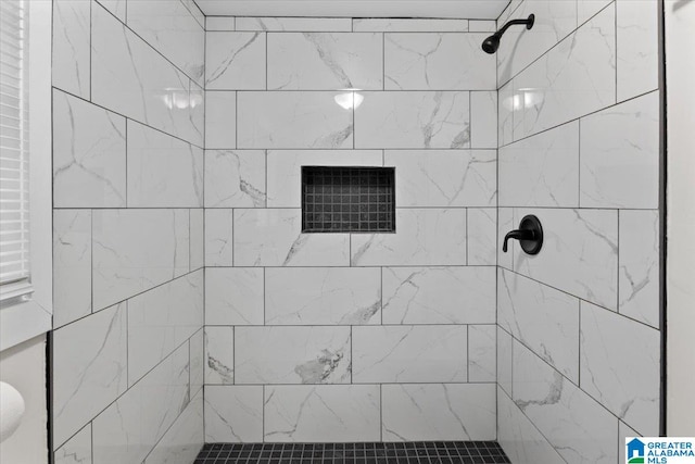 bathroom with a tile shower