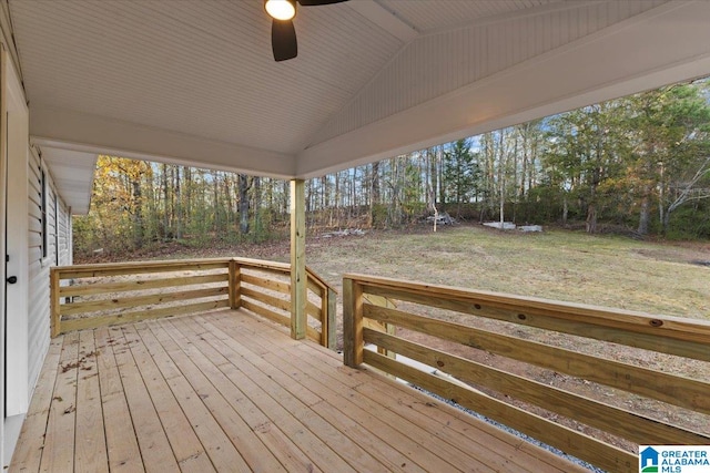 wooden deck with a lawn and ceiling fan