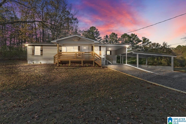 view of front of property with a deck and a carport