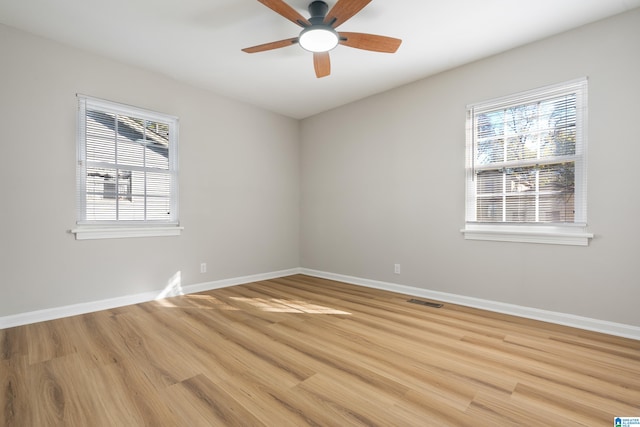 empty room featuring light wood-type flooring and ceiling fan