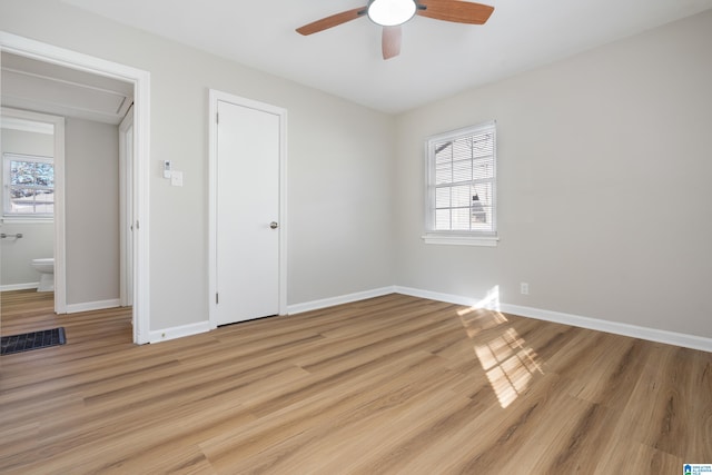 unfurnished bedroom with light wood-type flooring, multiple windows, and ceiling fan