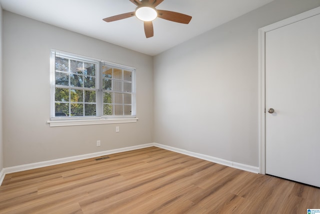 spare room featuring ceiling fan and light hardwood / wood-style flooring