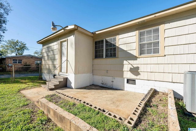 view of property exterior featuring central air condition unit and a patio