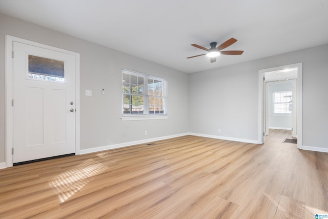 entryway with a wealth of natural light, ceiling fan, and light hardwood / wood-style floors