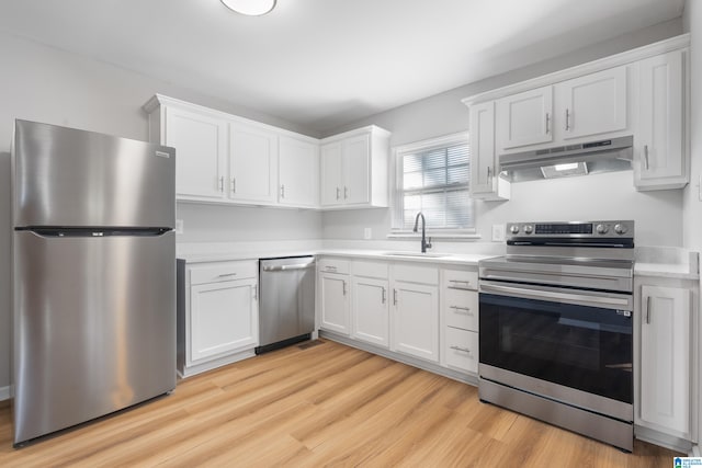 kitchen with light wood-type flooring, white cabinetry, sink, and appliances with stainless steel finishes