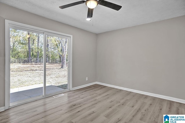 6129 Spruce Dr, Anniston, AL 36206 - unfurnished room featuring wood finished floors, baseboards, a ceiling fan, and a textured ceiling