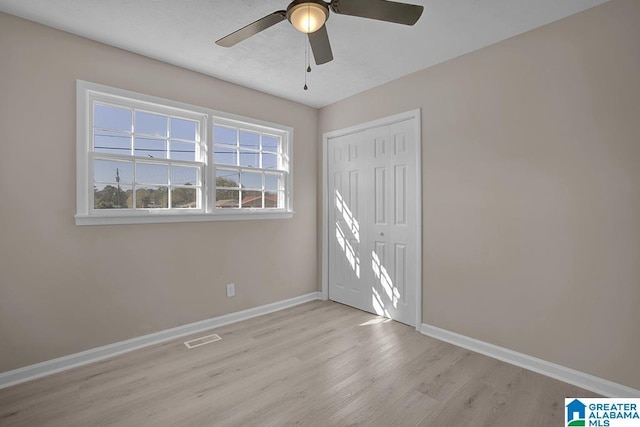 6129 Spruce Dr, Anniston, AL 36206 - unfurnished bedroom featuring wood finished floors, baseboards, a closet, and ceiling fan