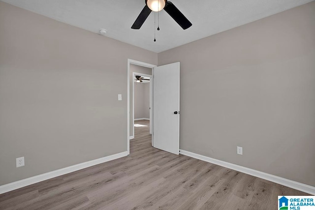 empty room with ceiling fan and light wood-type flooring