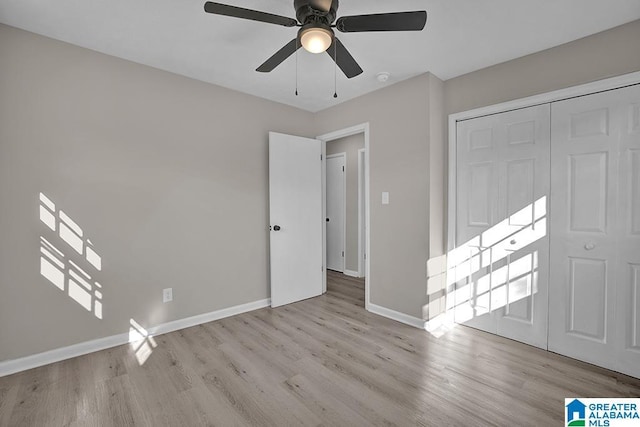 6129 Spruce Dr, Anniston, AL 36206 - unfurnished bedroom featuring wood finished floors, baseboards, a ceiling fan, and a closet