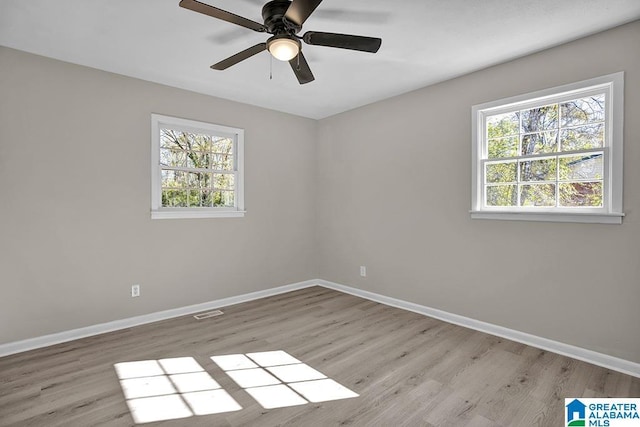 6129 Spruce Dr, Anniston, AL 36206 - unfurnished room featuring plenty of natural light, baseboards, and light wood finished floors