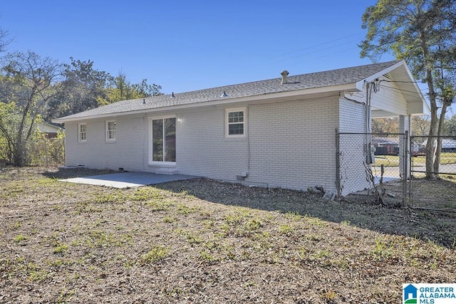 6129 Spruce Dr, Anniston, AL 36206 - back of house with brick siding, a patio, and a gate