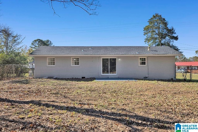 rear view of house with a lawn