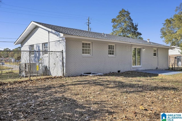 6129 Spruce Dr, Anniston, AL 36206 - back of house with brick siding, a patio area, and roof with shingles