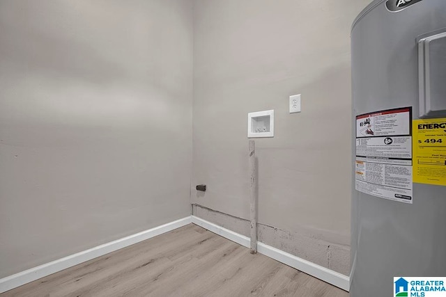 laundry room featuring hookup for a washing machine, electric water heater, and light hardwood / wood-style flooring