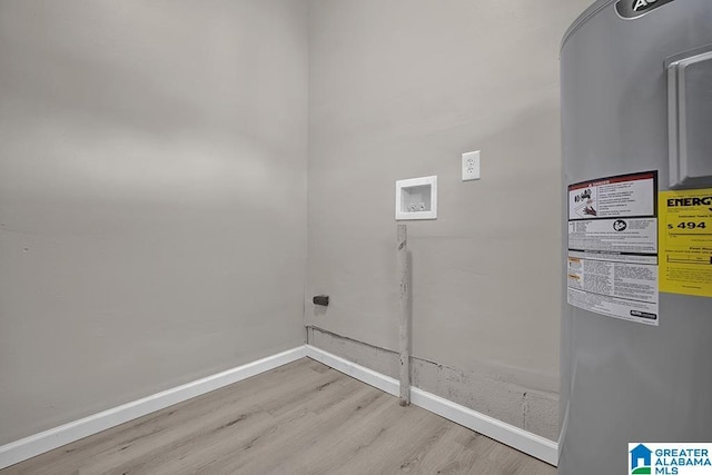 6129 Spruce Dr, Anniston, AL 36206 - laundry area with water heater, light wood-type flooring, hookup for a washing machine, and baseboards