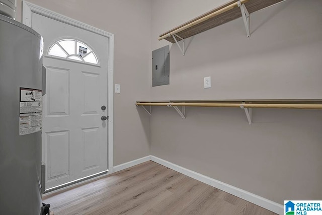 entryway featuring light hardwood / wood-style floors, electric water heater, and electric panel