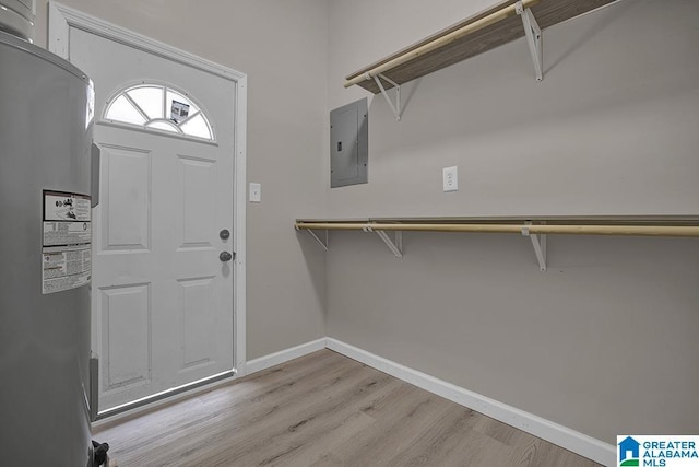 6129 Spruce Dr, Anniston, AL 36206 - entrance foyer with water heater, electric panel, wood finished floors, and baseboards