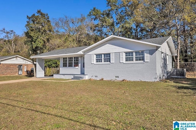 single story home with a carport, central AC, and a front lawn