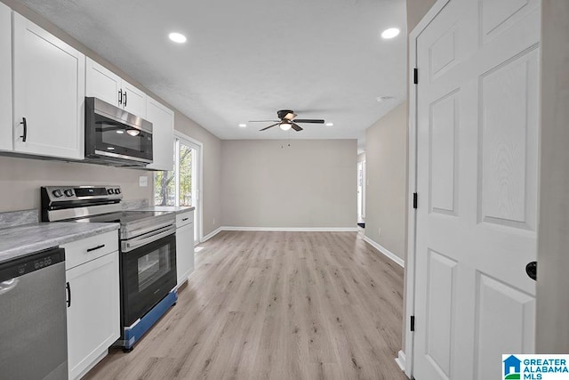 kitchen with ceiling fan, white cabinetry, appliances with stainless steel finishes, and light hardwood / wood-style flooring