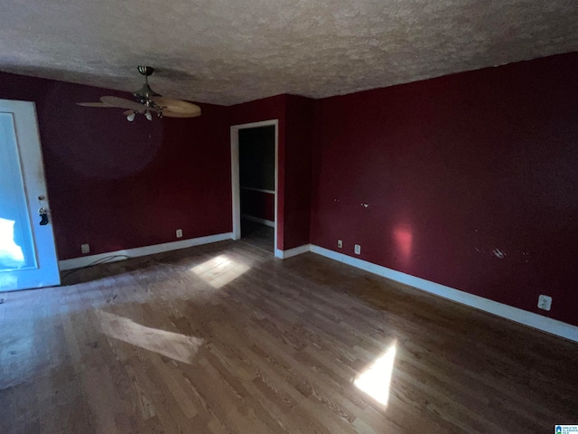 spare room featuring hardwood / wood-style floors, ceiling fan, and a textured ceiling