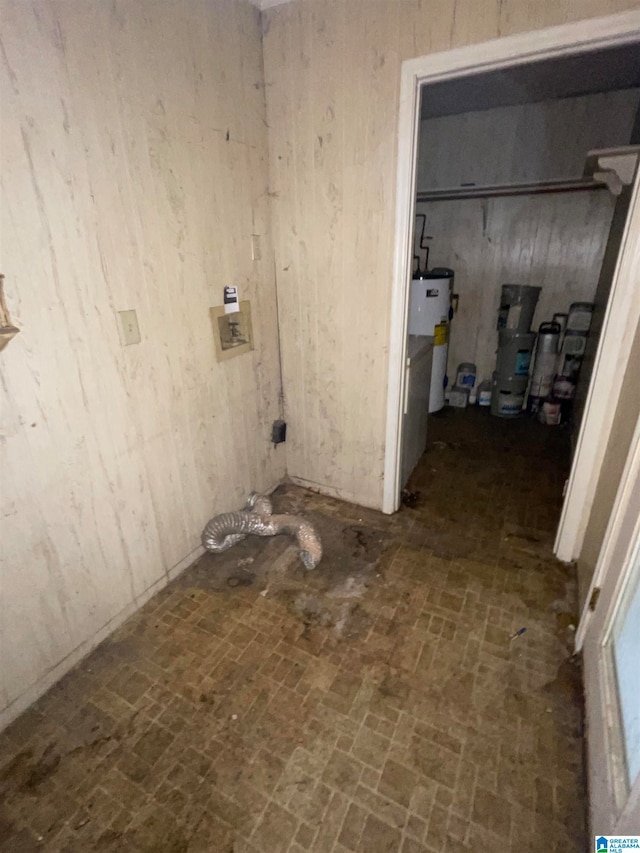 clothes washing area with water heater