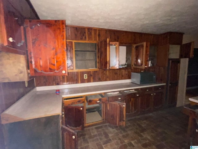 kitchen featuring wood walls