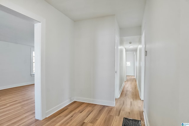 hall with light hardwood / wood-style floors