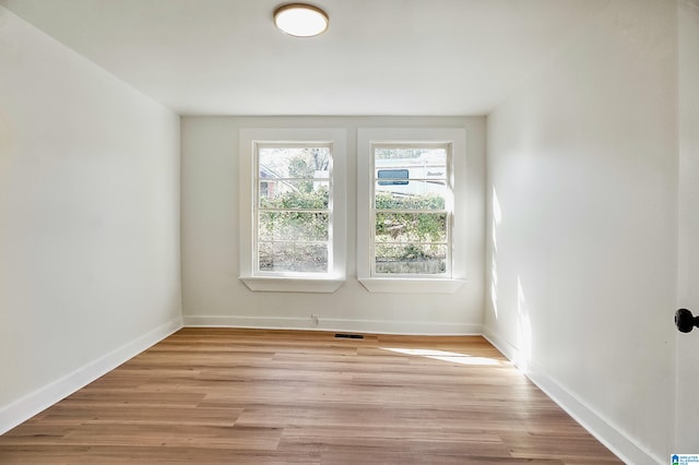 empty room with light hardwood / wood-style floors