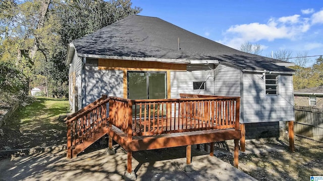 rear view of house featuring a wooden deck