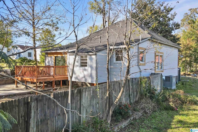 back of property featuring central AC unit and a wooden deck