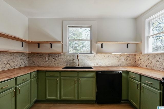 kitchen with sink, wooden counters, green cabinetry, and black dishwasher